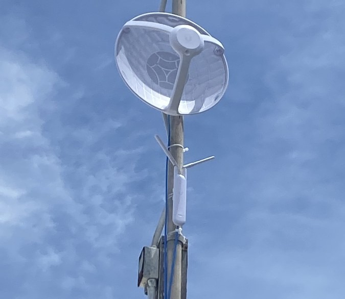 Ubiquiti point-to-point wireless dish on tower